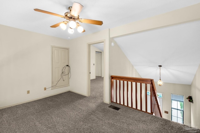 unfurnished room with ceiling fan, dark carpet, and lofted ceiling