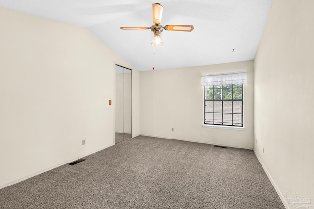 spare room with ceiling fan, carpet floors, and vaulted ceiling