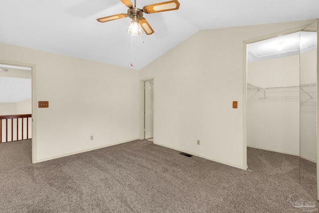 empty room featuring ceiling fan, carpet floors, and vaulted ceiling