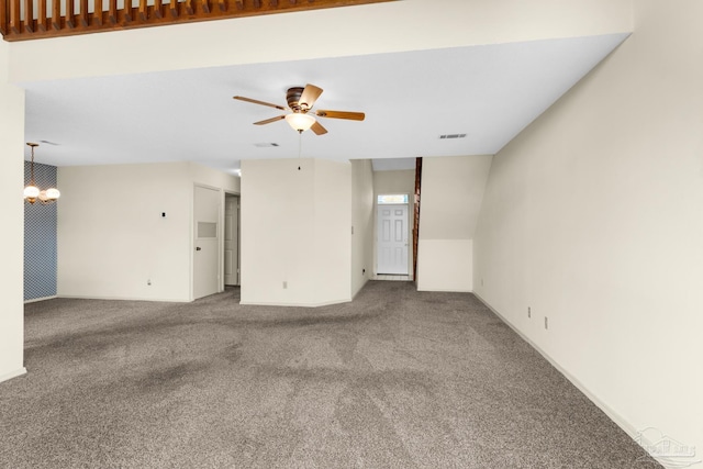 carpeted empty room with ceiling fan with notable chandelier