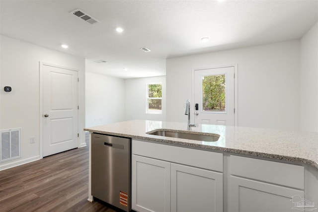 kitchen featuring stainless steel dishwasher, a sink, dark wood finished floors, light stone counters, and white cabinetry