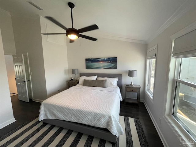 bedroom featuring visible vents, lofted ceiling, crown molding, and baseboards