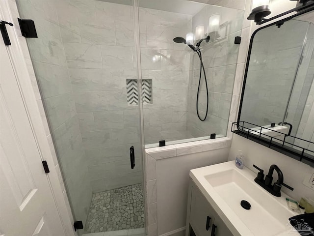 bathroom featuring vanity and a shower stall