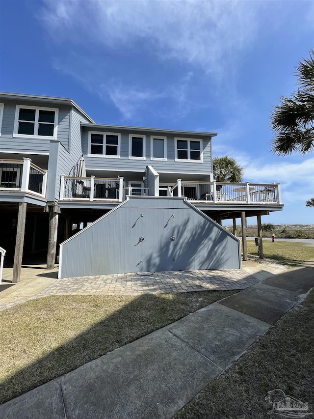 raised beach house featuring a deck