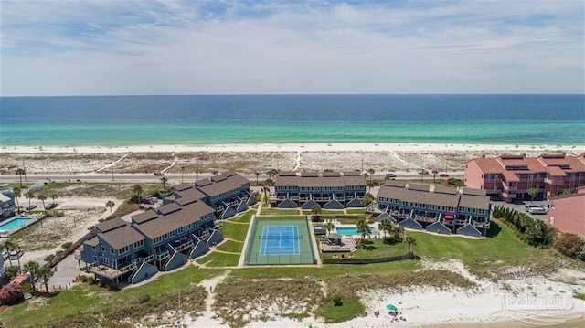 drone / aerial view with a beach view and a water view