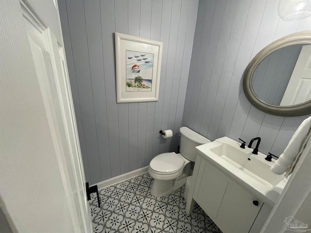 bathroom with vanity, tile patterned floors, toilet, and baseboards