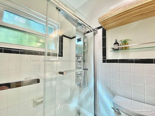 bathroom with a shower with door and toilet