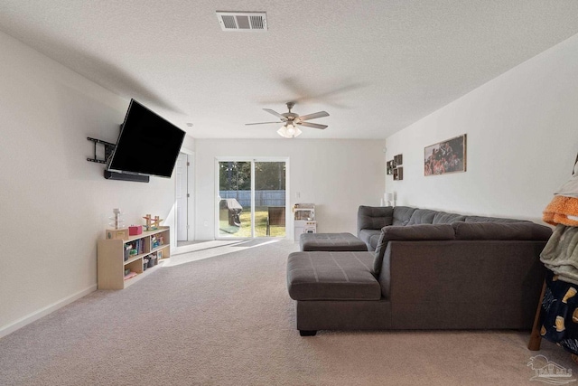 carpeted living room with visible vents, ceiling fan, a textured ceiling, and baseboards