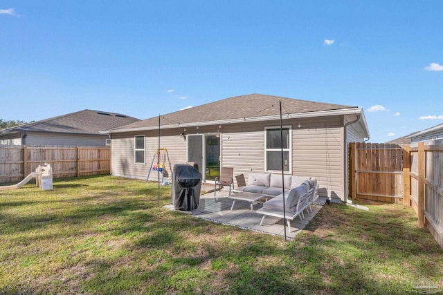 back of house with roof with shingles, a fenced backyard, a patio, and a lawn