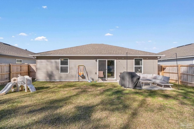 back of house featuring a fenced backyard, a shingled roof, a patio, and a yard