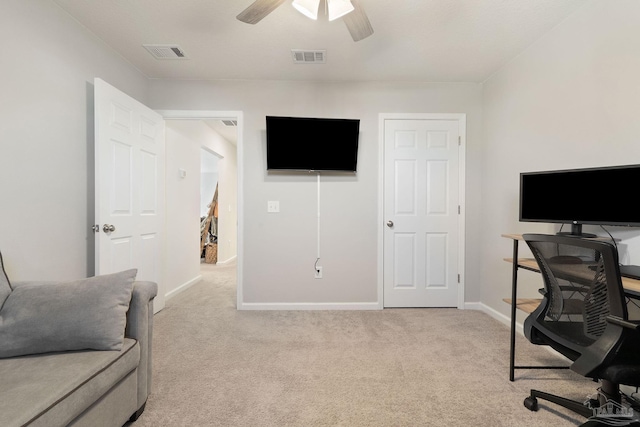 home office featuring ceiling fan, visible vents, and light colored carpet