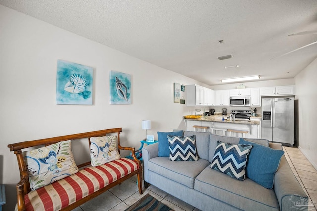 tiled living room with a textured ceiling