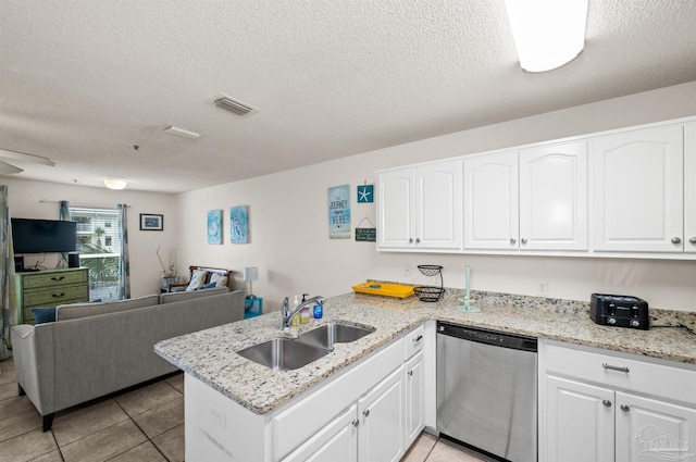 kitchen with kitchen peninsula, dishwasher, white cabinets, and sink