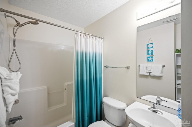 full bathroom with shower / bath combo, a textured ceiling, toilet, and sink