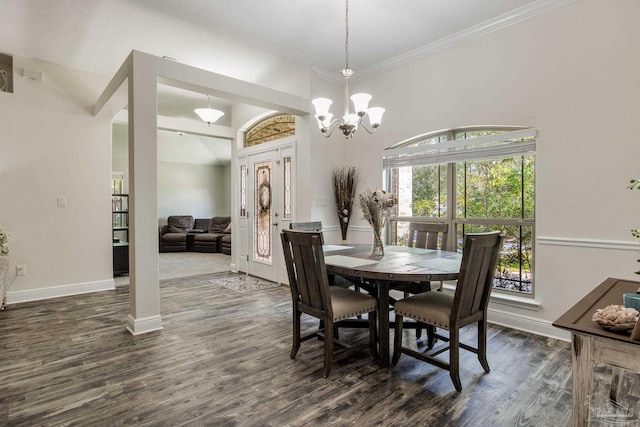 dining room featuring dark wood-style floors, baseboards, ornamental molding, and a chandelier