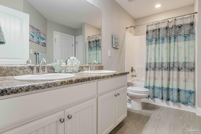 full bathroom with vanity, toilet, wood-type flooring, and shower / bath combo with shower curtain