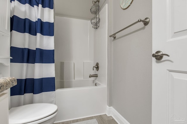 bathroom featuring hardwood / wood-style floors, shower / bath combination with curtain, and toilet