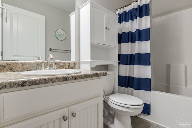 full bathroom featuring toilet, vanity, and shower / tub combo with curtain