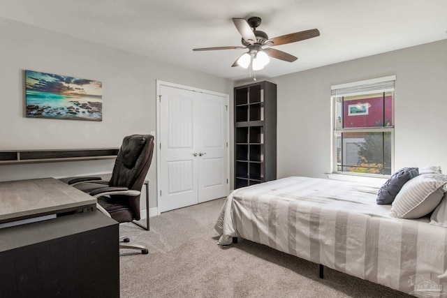 bedroom with light carpet, a closet, and ceiling fan