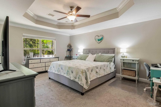 bedroom featuring a raised ceiling, crown molding, ceiling fan, and light carpet