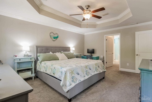 carpeted bedroom with a raised ceiling, ceiling fan, and ornamental molding