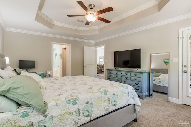 carpeted bedroom featuring a tray ceiling, ceiling fan, and ornamental molding