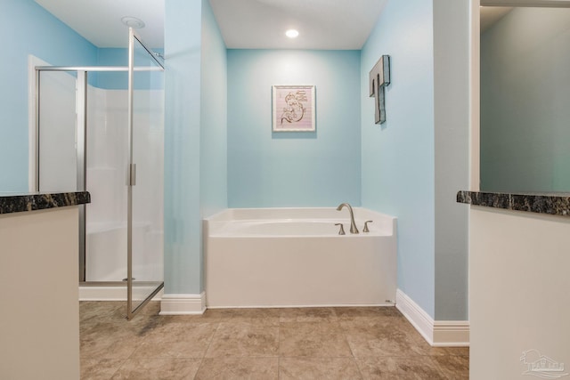 bathroom with tile patterned floors and independent shower and bath