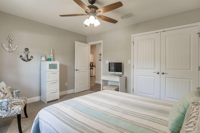 carpeted bedroom featuring a closet and ceiling fan