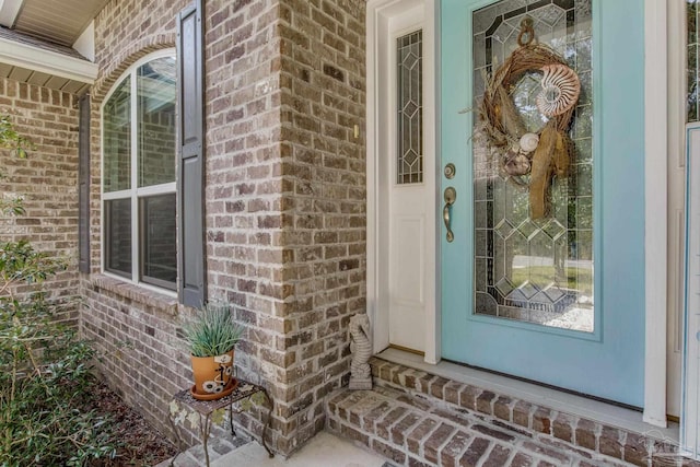 property entrance with brick siding