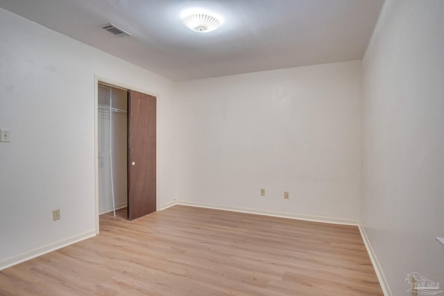 unfurnished bedroom featuring a closet and light hardwood / wood-style flooring