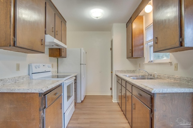 kitchen featuring sink, white range with electric cooktop, and light hardwood / wood-style flooring