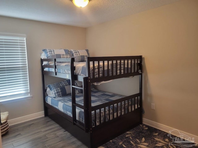 bedroom with wood-type flooring and a textured ceiling