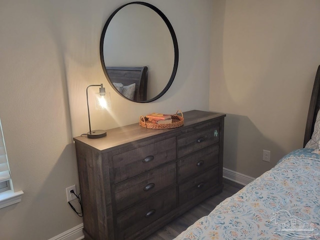 bedroom with dark hardwood / wood-style flooring