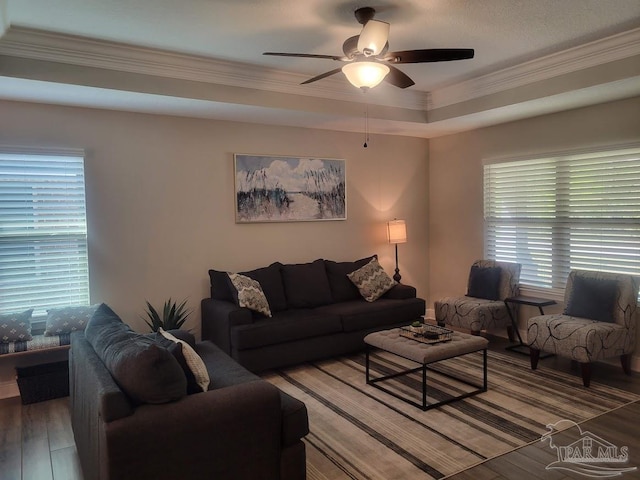 living room featuring hardwood / wood-style flooring, ceiling fan, a healthy amount of sunlight, and ornamental molding