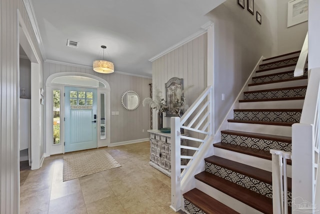 entryway featuring baseboards, stairs, visible vents, and crown molding