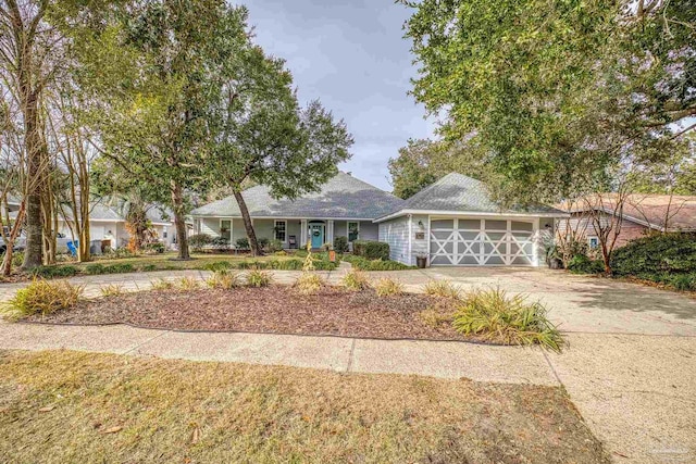 single story home featuring a garage and driveway