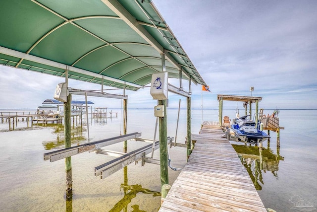 dock area with a water view and boat lift