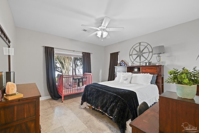 bedroom with a ceiling fan, visible vents, and baseboards