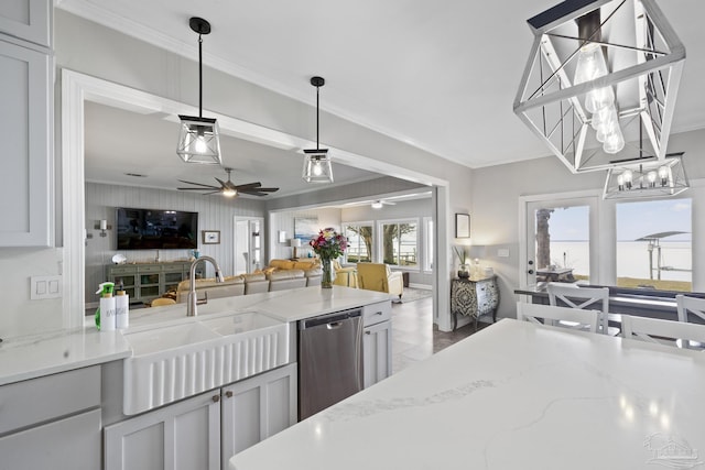 kitchen featuring a sink, crown molding, open floor plan, and stainless steel dishwasher