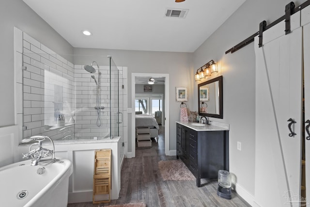 full bath with visible vents, a freestanding bath, a ceiling fan, a stall shower, and wood finished floors