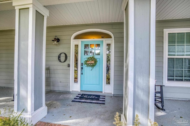 view of exterior entry with covered porch