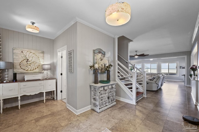 entryway with ceiling fan, ornamental molding, stairway, and baseboards