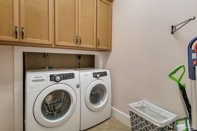 2961 Bay St, Gulf Breeze, FL 32563 - laundry room with independent washer and dryer, cabinet space, light tile patterned flooring, and baseboards