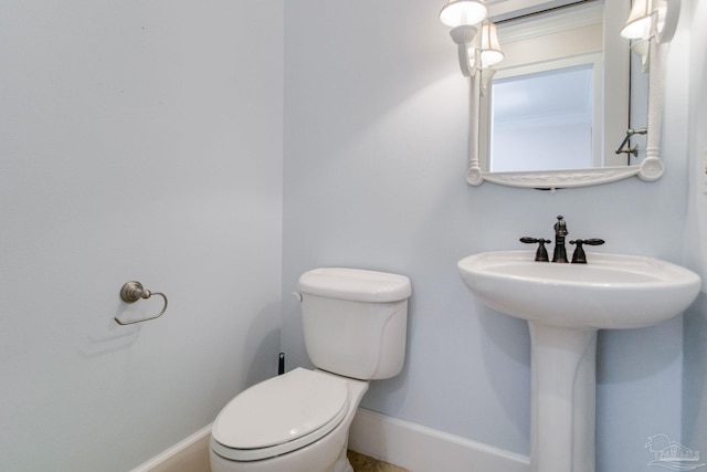 2961 Bay St, Gulf Breeze, FL 32563 - bathroom featuring toilet, baseboards, and a sink