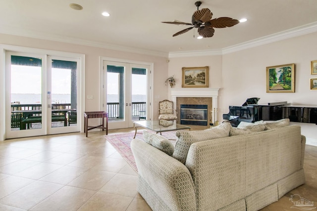 2961 Bay St, Gulf Breeze, FL 32563 - living area featuring crown molding, a glass covered fireplace, a ceiling fan, light tile patterned floors, and recessed lighting