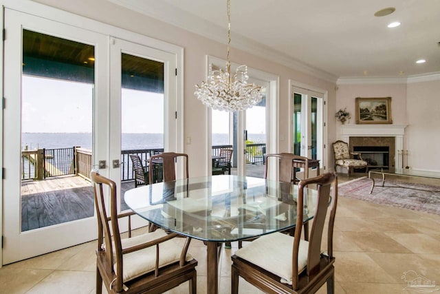 2961 Bay St, Gulf Breeze, FL 32563 - dining room featuring ornamental molding, french doors, a fireplace, a water view, and a chandelier