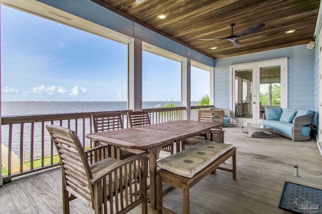 2961 Bay St, Gulf Breeze, FL 32563 - wooden deck featuring a water view, ceiling fan, and outdoor dining space