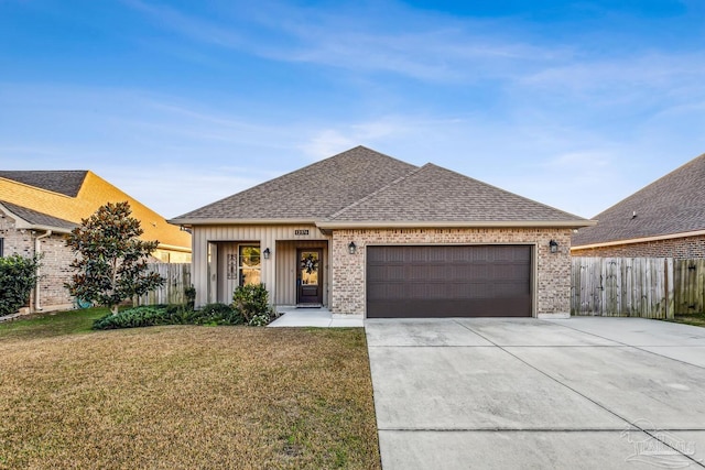 view of front of home with a garage and a front lawn