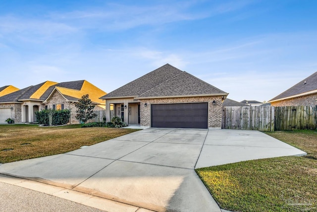 view of front facade with a garage and a front lawn