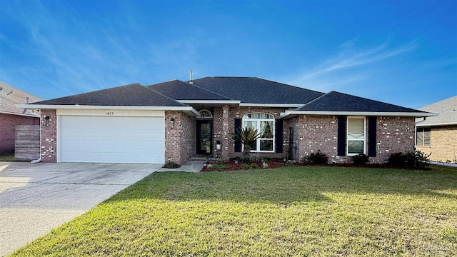 ranch-style house with a shingled roof, concrete driveway, an attached garage, a front yard, and brick siding